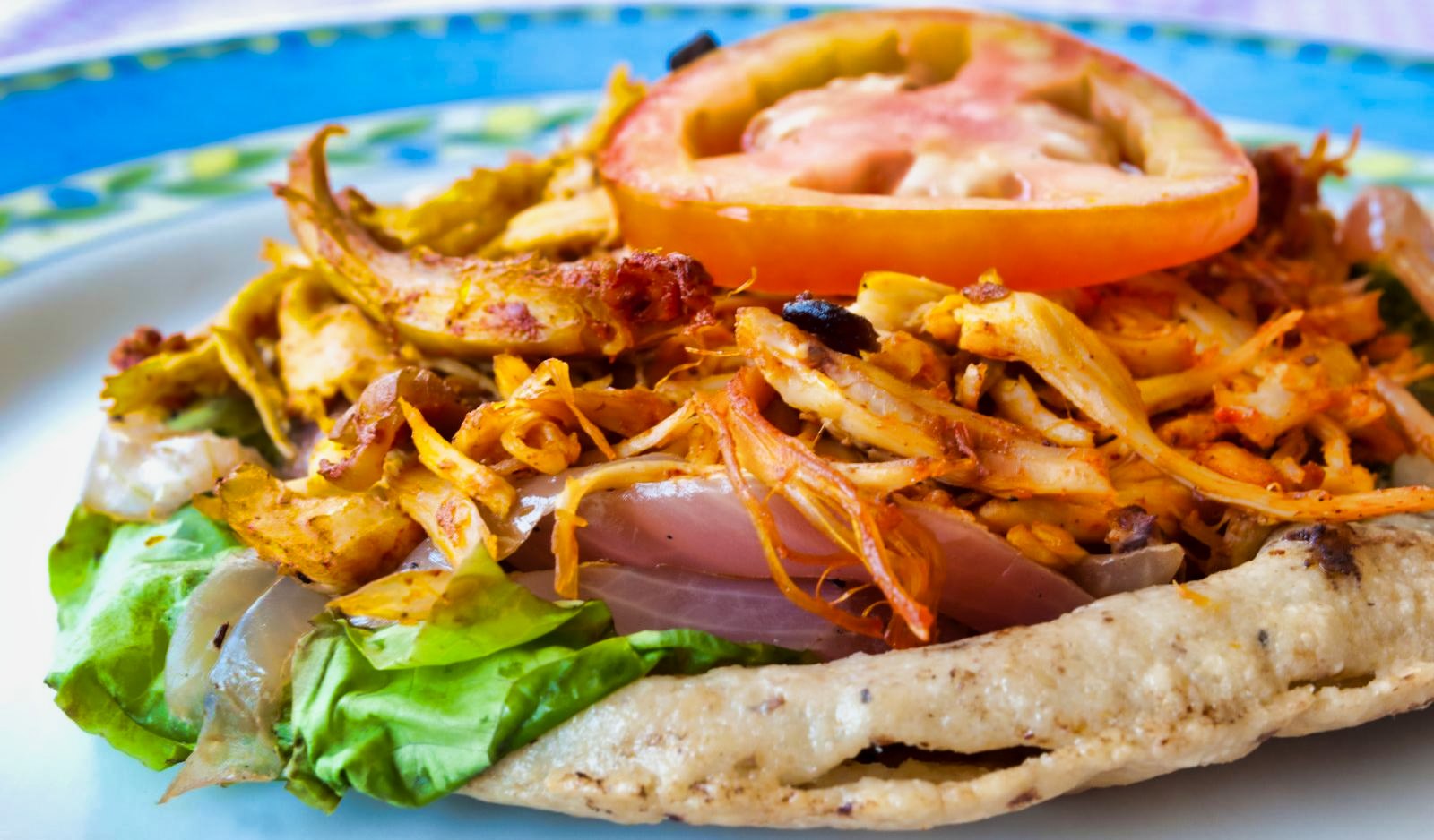 Panucho ($1.30 / 27 Pesos)- a Yucatán specialty tortilla stuffed with refried beans, then layered with your choice toppings.