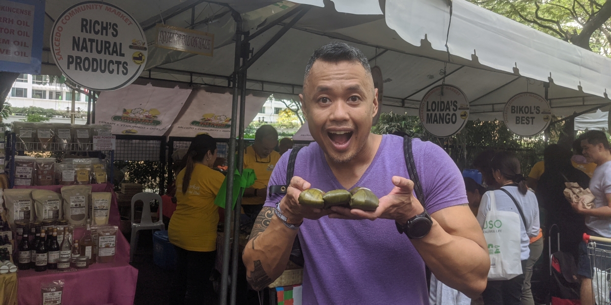 Nomadic FIRE- Cost of Living In The Philippines Cover Marco Sison eating at a local market to see if street food is safe in the Philippines for expats