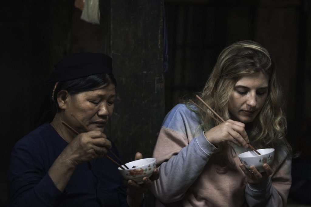 retired in Vietnam two women eating with chopsticks