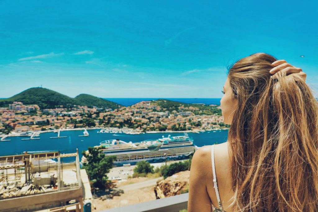 A woman enjoying expat life in Croatia with a view of Dubrovnik
