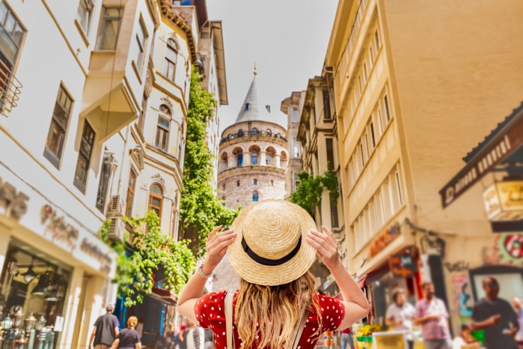 Woman living in Turkey as a Foreigner looking at the Galata Tower